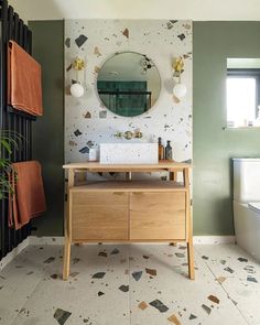 a bathroom with a sink, mirror and bathtub in it's center area