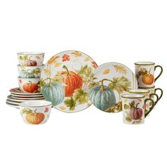 an assortment of dishes and cups with pumpkins on them