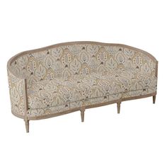 an ornately designed couch with wooden legs and fabric upholstered backrests