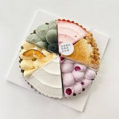 a piece of cake that is on top of a paper with different types of pies in it