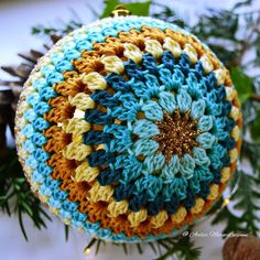 a crocheted ornament hanging from a christmas tree