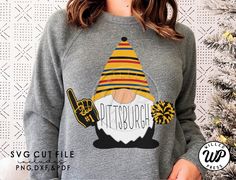 a woman wearing a grey sweatshirt with an image of a gnome holding a skateboard