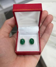 Featured here is a beautiful set of oval cut cabochon emerald studs in fine 14K yellow gold. Displayed are rich-green emeralds with very good transparency, accented by a simple four-prong claw gold mount, allowing for the emerald to be shown in full view. The earth mined, green cabochon emeralds have a desirable lush green color with excellent qualities. These earrings are ideal for everyday use and are the perfect accessory to any outfit. Setting Style: Four Prong Setting Material: 14K Yellow G Classic Oval Cabochons For Anniversary, Oval Cabochons For Formal Wear Fine Jewelry, Oval Yellow Gold Cabochons For Formal Events, Classic Oval Gemstone Cabochons, Oval Polished Cabochons For Gifts, Green Oval Cabochons Fine Jewelry, Luxury Oval Cabochon Gemstone Earrings, Oval Cabochon Fine Jewelry Earrings For Gifts, Oval Cabochon Fine Jewelry As Gift