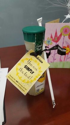 a cup of ice cream sitting on top of a wooden table next to a sign