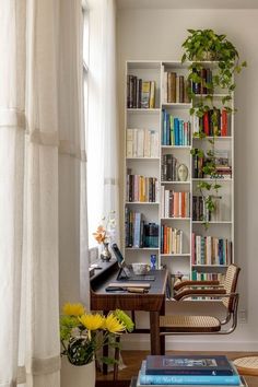 a living room filled with lots of books and furniture