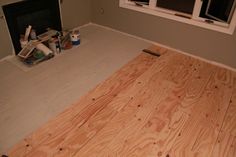 an unfinished room with wood floors and a fire place