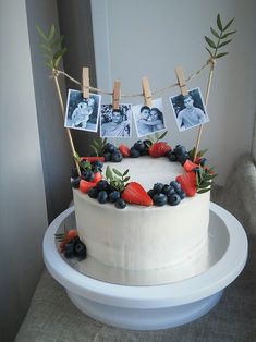 a white cake with berries and blueberries on top