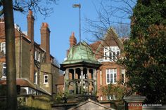 a clock tower in front of some buildings