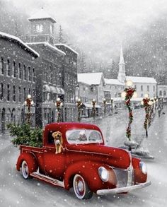 an old red truck with a christmas tree in the back is driving down a snowy street