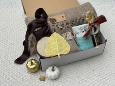 a box filled with assorted items sitting on top of a white carpeted floor