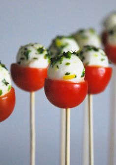 some food on sticks with tomatoes and cheese