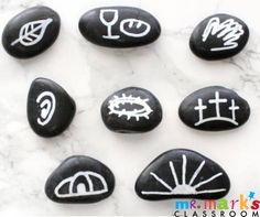 six rocks with different symbols painted on them