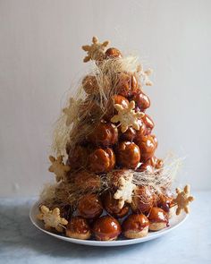 a white plate topped with lots of food on top of a blue tablecloth next to a wall