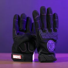 MARVEL BLACK PANTHER WORKGLOVES: Tackle any problem from home repairs to throne usurpers with these Marvel Black Panther Work Gloves. Fitting for Wakanda, these technologically-advanced gloves are made with a combination of neoprene, spandex, and TPR and have touchscreen-compatible pads on the thumbs, index, and middle fingers so you can still use your phone. The purple detail stitching really shows off Black Panther's insignia. Size: One Size.  Gender: male.  Age Group: adult. Middle Fingers, Marvel Black Panther, Purple Details, Black Panther Marvel, Purple Guy, Work Gloves, Home Repairs, Teen Boy, Mens Gloves