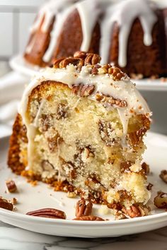 a close up of a piece of cake on a plate with pecans around it