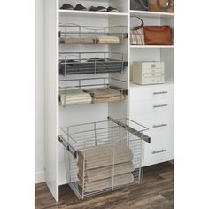 an organized closet with white shelves and baskets