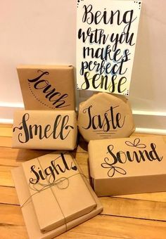 four wrapped presents sitting on top of a wooden floor next to a sign that says smile sound