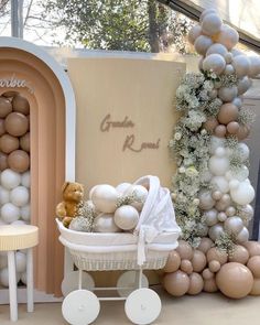 a baby's carriage with balloons and decorations