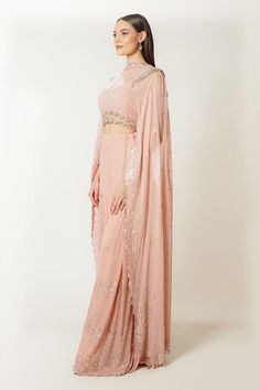 Blush pink georgette blouse with an attached dupatta and sequins, thread and zari embroidery. Comes with box-pleated palazzo.
Components: 2
Pattern: Embroidered
Type Of Work: Sequins, Thread, Zari
Neckline: High Neck
Sleeve Type: Flared Sleeves
Fabric: Georgette
Color: Pink
Other Details: 
Closure: Blouse - Back hooks
Occasion: Sangeet - Aza Fashions Pink Georgette Sets With Cutdana, Pink Pre-draped Floor-length Saree For Navratri, Pink Floor-length Pre-draped Saree For Navratri, Semi-stitched Blouse With Sheer Dupatta For Reception, Pink Chinon Pre-draped Saree For Navratri, Pink Floor-length Blouse Piece With Sheer Dupatta, Pink Floor-length Pre-draped Saree With Cutdana, Pink Georgette Sets With Traditional Drape, Pink Semi-stitched Floor-length Pre-draped Saree