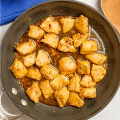 some food is cooking in a skillet on the stove and ready to be eaten