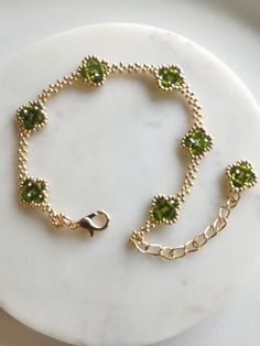 Meet our Handmade Four-Leaf Clover Bracelet - a symbol of luck and style.  Created with 3mm faceted beads and galvanized gold Miyuki seeds, this bracelet adds a touch of charm to your everyday look. Adjustable from 6.5 to 8.5 inches, it ensures a comfortable fit.                          Want a custom fit? Leave a message for your preferred length and enjoy the simplicity of personalized beauty. Lucky vibes, effortless style - that's our Four-Leaf Clover Bracelet. This product features a lobster clasp for the adjustable version, with a length of 6.5-8.5 inches, and a magnetic clasp for the fixed version, with selectable lengths.  Note that thread may be visible as it is handmade. Please note that there may be slight color differences between the images and the actual product. Beaded Clover Bracelet, Beaded Leaf Bracelet, Handmade Bracelets Thread, Four Leaf Clover Bracelet, Symbol Of Luck, Clover Bracelet, Beaded Leaf, Beaded Bracelets Tutorial, Beading Jewelery