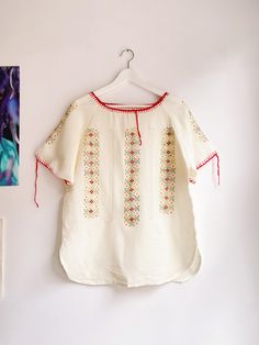 PLEASE NOTE new orders will be shipped after 13th of March due to holiday 💝 please enjoy 15% off the whole collection 💕   Vintage cotton folklore top with embroidery. From the seventies. Lovely embroidery with green and red threads. Cute details. In a used condition, some little signs but nothing major. Fits for size L or XL, but please check measurements to be sure. size L / XL armpit to armpit: 55cm length: 70cm Please compare it with a garment you already own to be sure :) Thank you for visiting my shop <3  { Please read this before shopping } -  Please note that you are buying a vintage garment, garments will not be as new but I check each item very well. Major flaws are always noted in description. Everything is steamed before shipping - All sales are final  - Within Europe I ship m Folk Blouse With Multicolor Embroidery Motif, Folk Style Peasant Tunic Top With Floral Embroidery, Folk Style Peasant Top With Floral Embroidery, Bohemian Festival Top With Embroidered Hem, Bohemian Tops With Embroidered Hem For Festivals, Floral Embroidered Tunic Top For Festival, Festive Tunic Top With Embroidered Neckline, Folk Style Short Sleeve Peasant Top With Embroidered Border, Folk Style Peasant Top With Embroidered Border