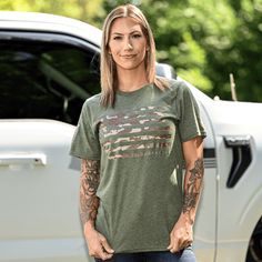 WOMEN'S BOYFRIEND FIT ARMY GREEN CAMO AMERICAN PATRIOTIC T-SHIRT 🇺🇸 Knit, Dyed, Cut & Sewn in America Our best-selling camo American flag design is now available in a new Army green color! The Women's Camo American Flag Patriotic Boyfriend Fit T-Shirt is the perfect blend of classic Americana and OCP-style camo. Screen printed on a lightweight, ultra-soft poly/cotton shirt in heather Army green BOYFRIEND FIT - Longer length, roomier sleeves, unisex fit. The model is 5'4" and 120 pounds and is Green Military Crew Neck T-shirt, Green Military Style Crew Neck T-shirt, Green Military Style T-shirt With Crew Neck, Khaki Military Crew Neck Top, Green Military Crew Neck Top, Relaxed Fit Camouflage Cotton T-shirt, Khaki Military Top With Relaxed Fit, Camouflage Short Sleeve T-shirt With Relaxed Fit, Casual Camouflage Relaxed Fit T-shirt