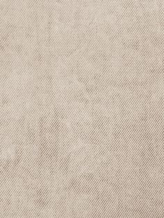 a beige fabric textured background with some small holes in the top right corner and bottom left corner