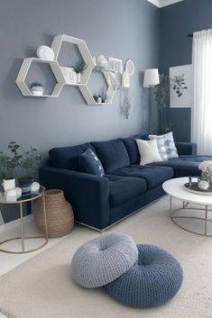 a living room with blue couches and white rugs in front of the windows