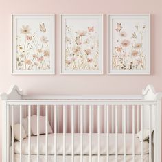 two paintings on the wall above a crib in a pink room with white furniture