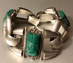 "This beautiful Mexican sterling silver stamped hinged panel bracelet boasts green carved stone mask panels alternating with silver panels. This green stone is commonly referred to as Mexican onyx, however, it's a misnomer and is probably a type of agate or obsidian. The bracelet dates to the 1940s-60s, and it would fit a small or medium lady's wrist. It's approximately 7.5 inches long and about 1 1/4\" wide at its widest points. It weighs about 1 1/2 ounces. In very good used vintage condition, Mexican Silver Jewelry, Mexican Mask, Weird Jewelry, Vintage Style Engagement Rings, Mexican Jewelry, Carved Stone, Onyx Bracelet, Green Onyx, Green Stone