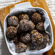 a white bowl filled with chocolate covered balls