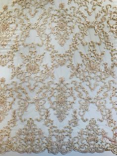 an embroidered white and gold fabric