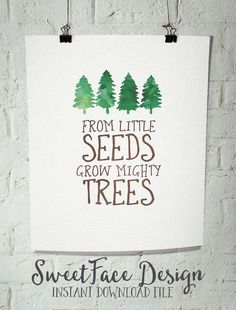 a white poster hanging on the wall next to a brick wall with trees painted on it