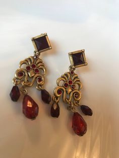 Elegant Red Crystal Goldtone Chandelier Dangling Earrings These gorgeous pierced earrings are nice matte gold tone with deep red sparkling crystals. They are Just over 2 inches long. In excellent recent 90's vintage condition. I will add new fresh backs. & gift nicely 🎀 www.MySoulRepair.com Red Chandelier Earrings For Formal Events, Formal Red Chandelier Earrings, Red Jeweled Metal Earrings, Ornate Red Earrings For Party, Red Vintage Dangle Chandelier Earrings, Vintage Red Dangle Chandelier Earrings, Red Vintage Chandelier Dangle Earrings, Red Metal Chandelier Earrings For Party, Red Formal Costume Jewelry Earrings