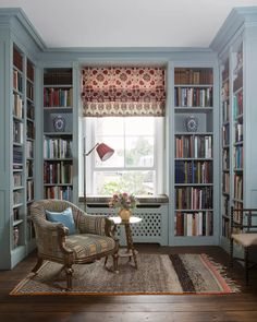 a room with bookshelves and a chair in it that is on instagram