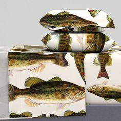 three boxes with fish on them sitting next to each other