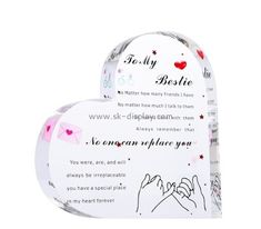 two heart shaped boxes with handwritten messages on the front and back, one in pink