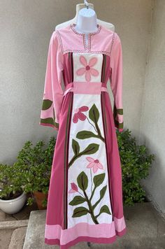 "Vintage bohemian custom made kaftan long dress pinks greens floral applications XS. Made of possible fabric cotton and polyester blend, no labels . angel sleeves, tie high waist. Good condition but has fade on shoulders, a couple mild spots in last 3 photos. Weight of dress 2 pounds Measurements Shoulders 15\" Sleeves 22\" Bust 36\" High Waist 34\" Waist 36\" Hips 46\" Length 57\"" Pink Embroidered Floor-length Kaftan, Fitted Long Pink Kaftan, Embroidered Pink Floor-length Kaftan, Pink Floral Embroidery Floor-length Maxi Dress, Pink Floral Embroidered Kaftan, Pink Hippie Dress For Spring, Spring Pink Hippie Dress, Spring Hippie Pink Dress, Pink Hippie Spring Dress