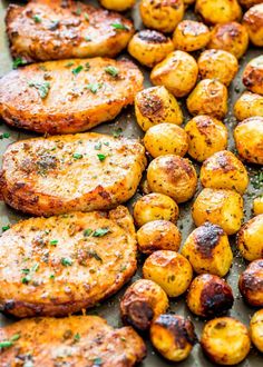 potatoes and meat on a baking sheet with parsley sprinkled on the top