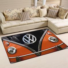 an orange and black vw camper van rug in the middle of a living room