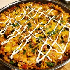 a casserole dish with cheese, meat and vegetables