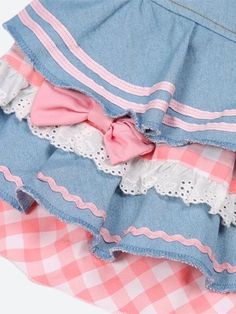 This denim mini skirt captures the kawaii aesthetic with its plaid layers, ruffle design, and heart-shaped plaid detail. Adorned with ribbons, lace, and bows, along with belt loops, it's a playful and stylish piece for casual or streetwear outfits. Kawaii aesthetic Plaid layer details Ruffle design Heart shaped plaid detail at front Ribbon & lace details Bows on skirt Belt loop details A-line Button & zip fastening Double pockets at front Cotton, polyester Cute Cotton Mini Skirt With Ruffles, Cute Cotton Ruffle Skirt, Cute Cotton Ruffled Skirt, Harajuku Style Ruffled Mini Skirt For Summer, Cute Blue Denim Skirt, Cute Cotton Tiered Skirt, Cute Cotton Skirt With Ruffles, Cute Tiered Cotton Skirt, Cotton Tiered Denim Skirt With Ruffles