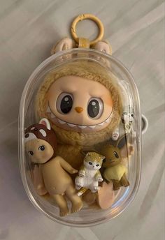 a keychain with an assortment of toy animals in it's packaging on a white surface