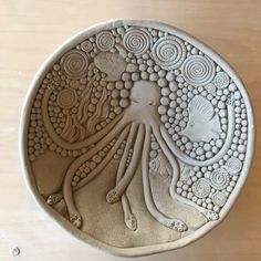 an intricately designed ceramic plate with an octopus