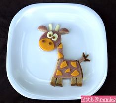 a white plate topped with a giraffe shaped cake