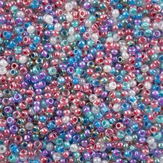 multicolored beads are shown in this close up photo, with one bead missing