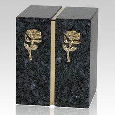 a black and gold box with a rose on it