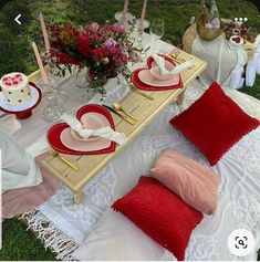 the table is set with red and white plates, napkins, and other decorations