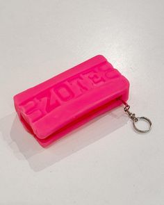 a pink keychain with the word detzone on it